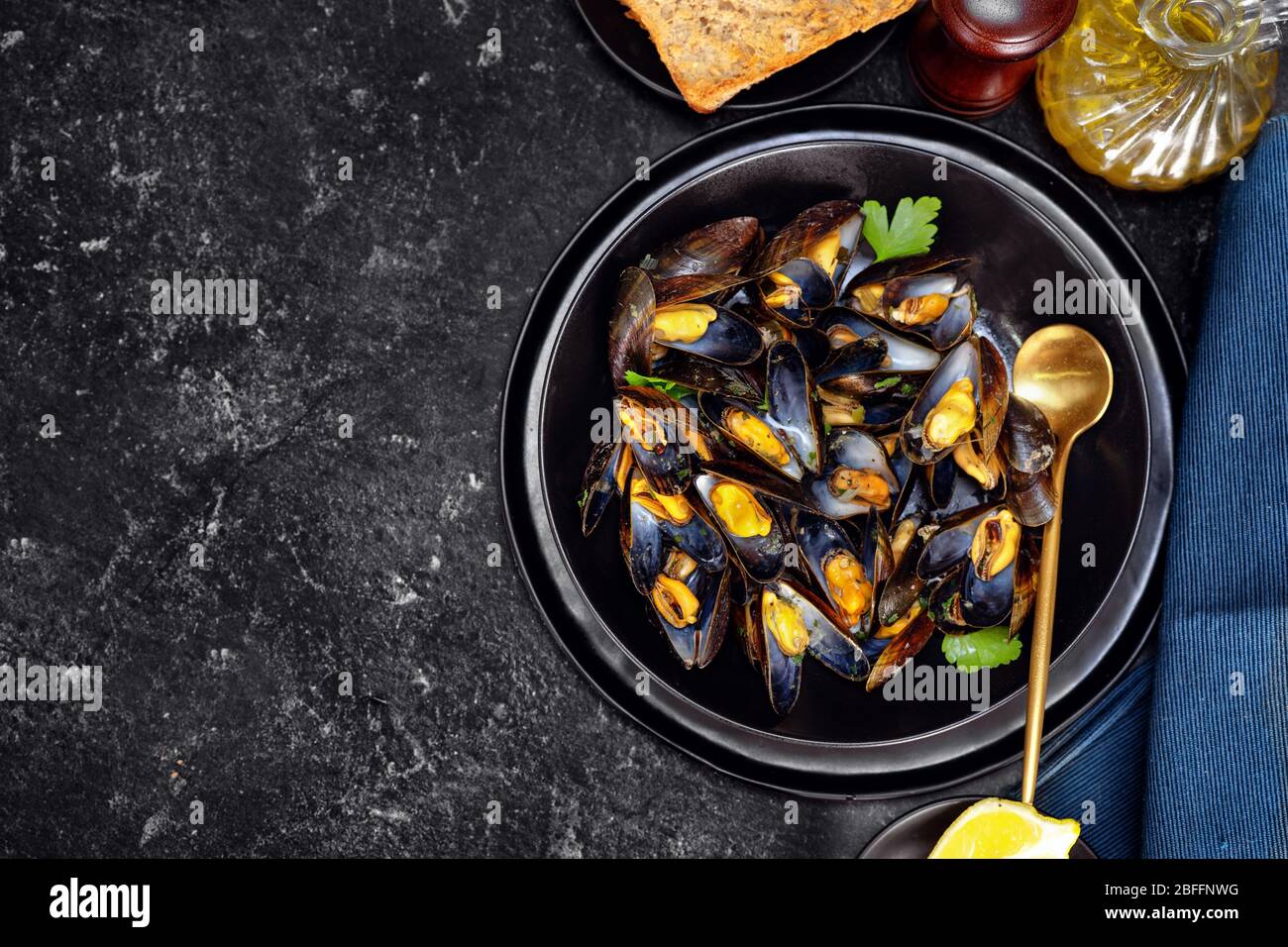 Top view of cooked mussels on black background Stock Photo