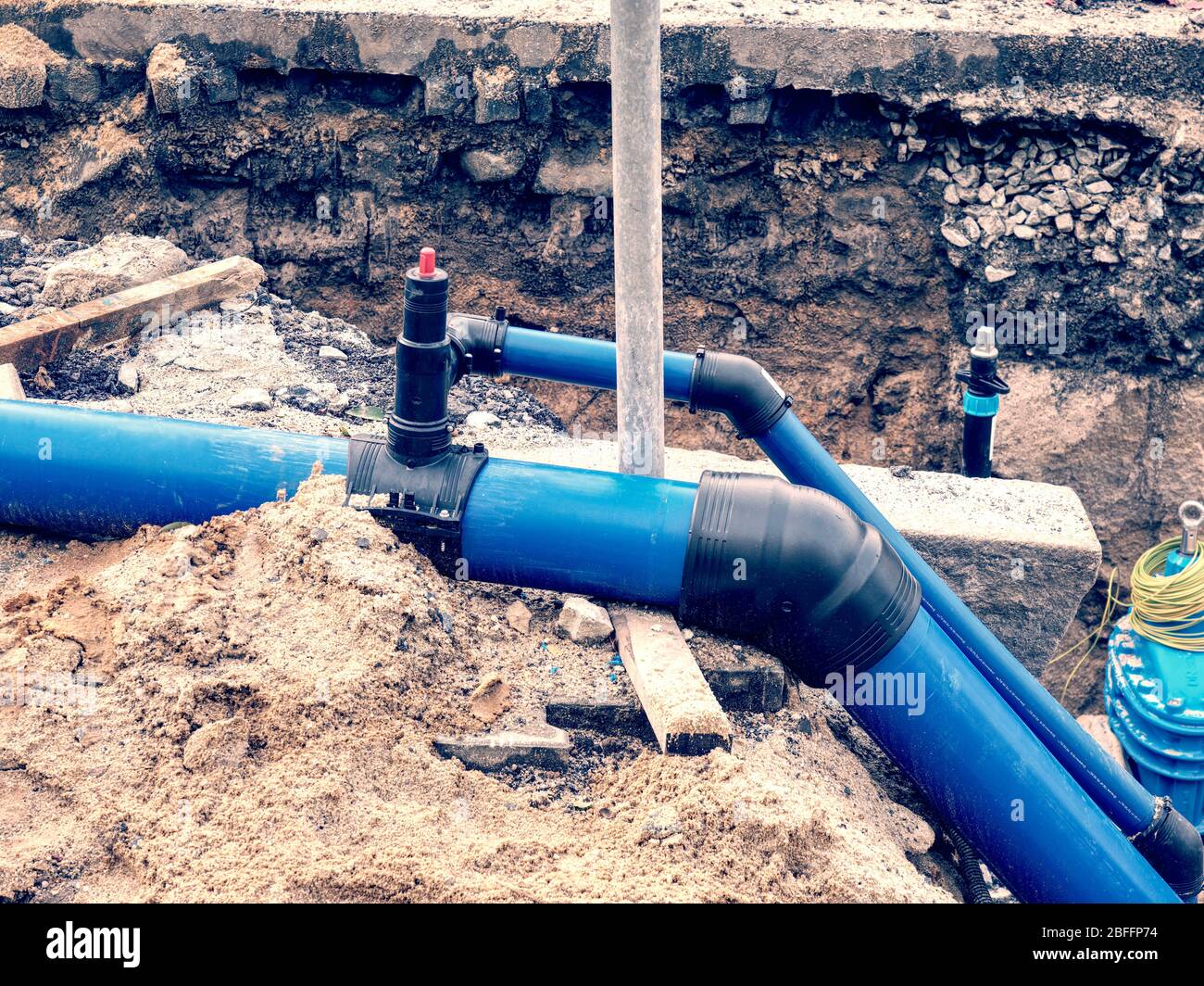 Replacing of broken pipes with PVC tubes for water delivery. Drink water  piping with 250mm waga multi joint member Stock Photo - Alamy