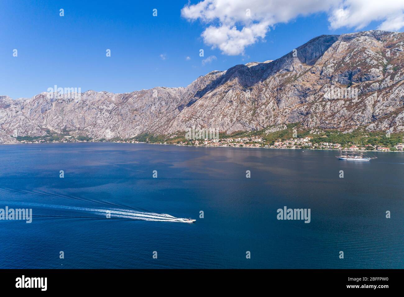 Aerial view of motor boats that run along the water surface leaving a ...