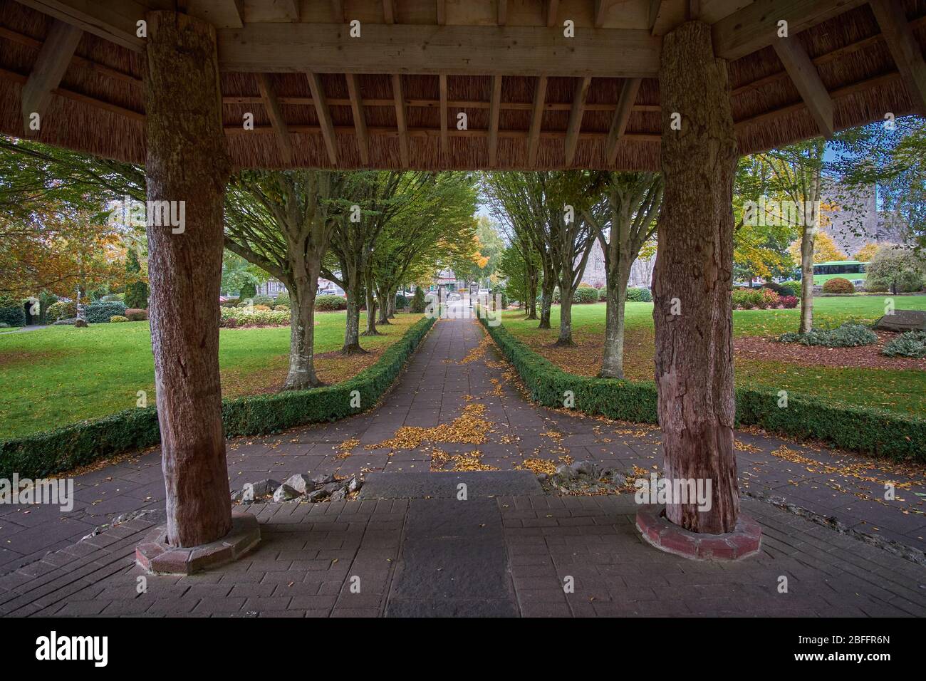 Peaceful view of the City park in Adare, County Limerick, Republic of Ireland on a autumn fall day in October looking out from gazebo Stock Photo