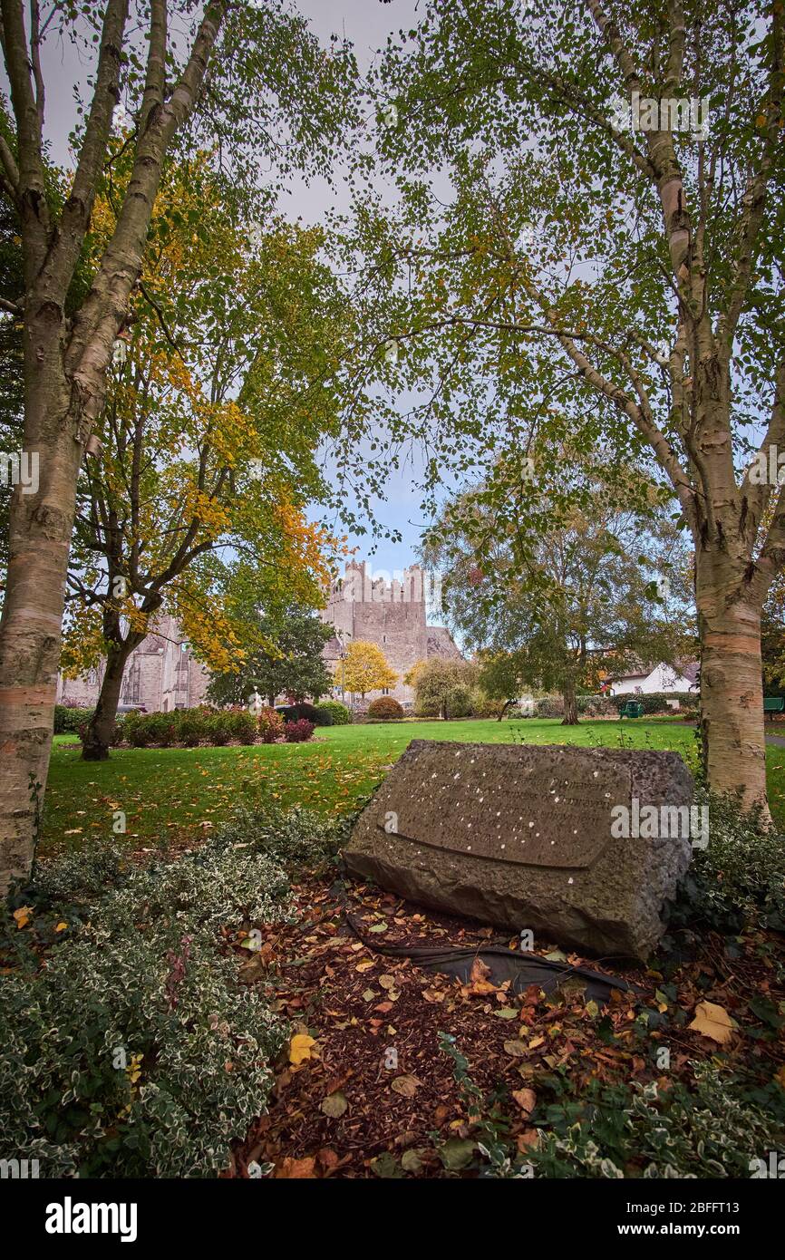 Peaceful view of the City park in Adare, County Limerick Ireland on a autumn fall day in October with Holy Trinity Abbey Church in background Stock Photo