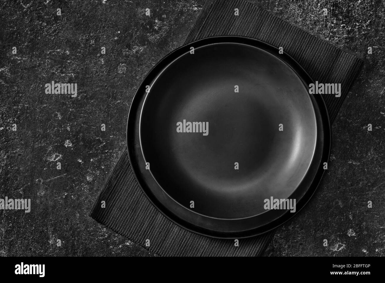 Top view of an empty black plate Stock Photo