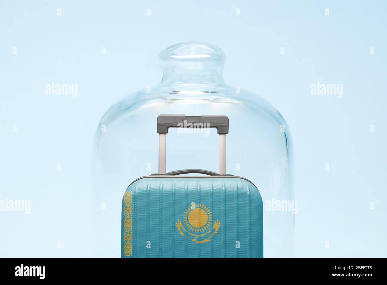 Suitcase with Kazakhstan flag design in quarantine minimal creative coronavirus travel restriction concept. Stock Photo