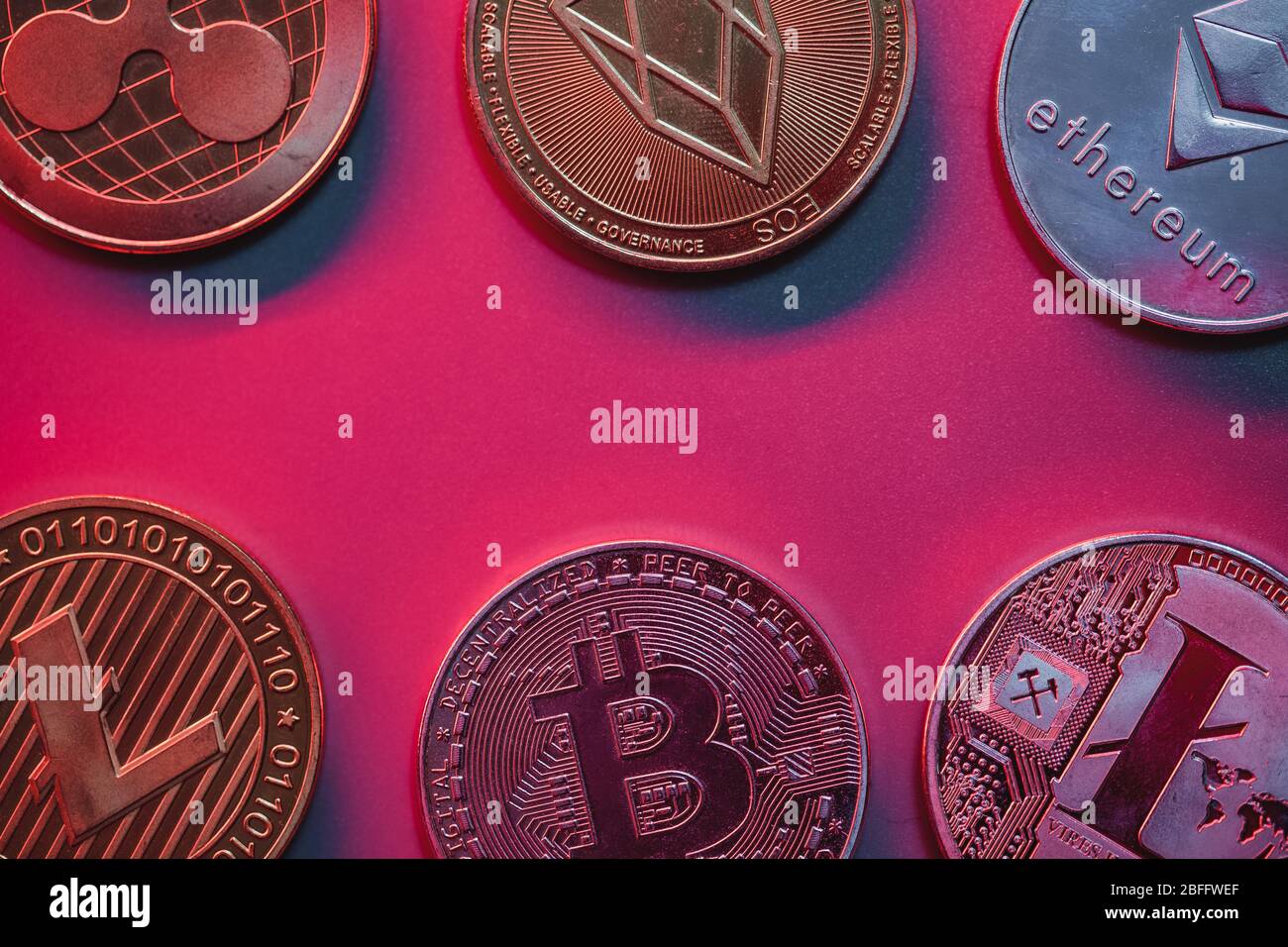 Stack of crypto coins on red, pink background with neon illumination Stock  Photo - Alamy
