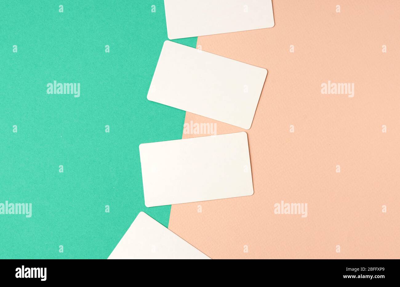 rectangular white blank business cards on a color background, backdrop for the designer Stock Photo