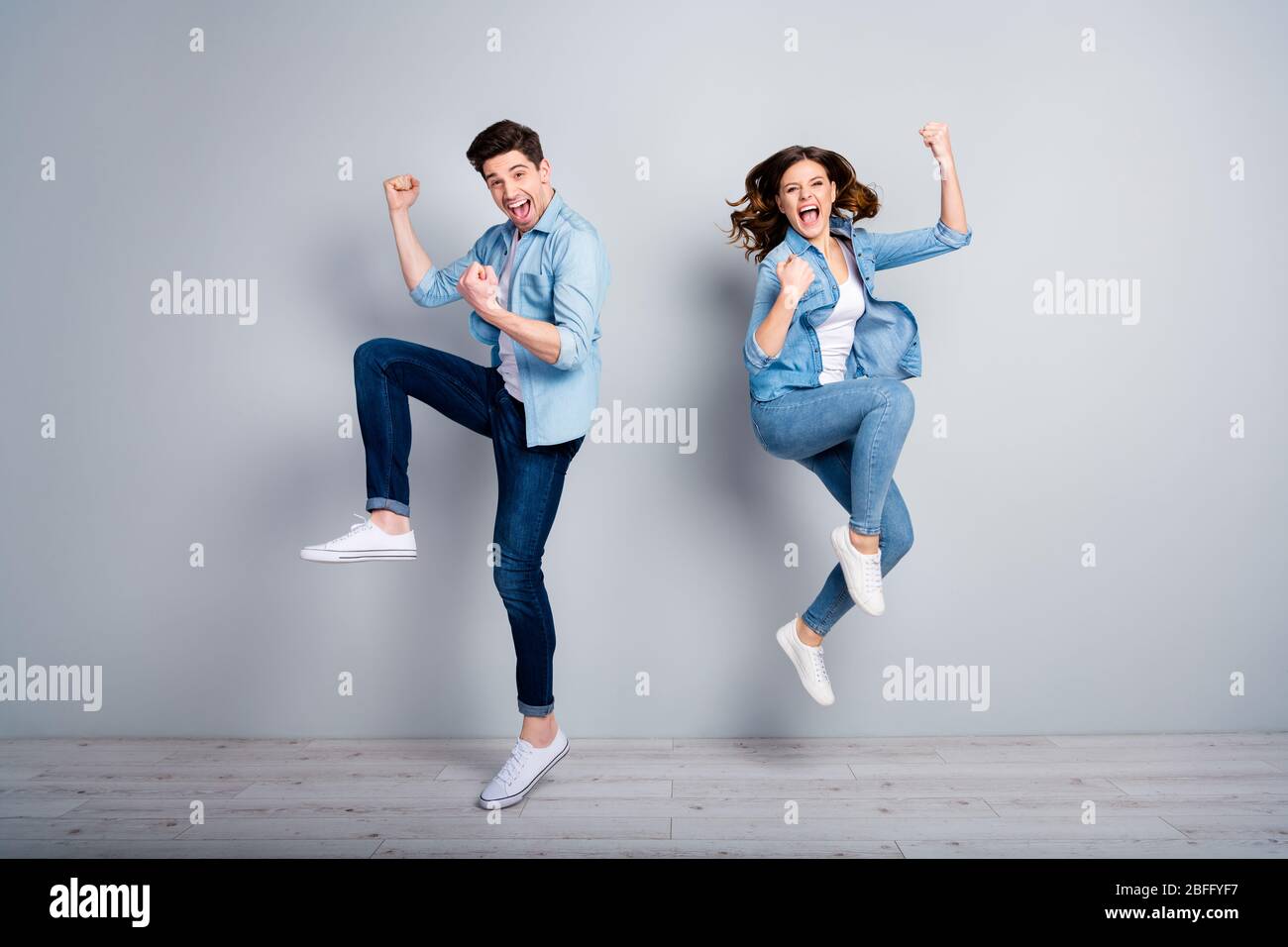 Full body photo of attractive lady handsome funny guy crazy fan jumping  high up celebrating football team winning wear casual denim shirts outfit  Stock Photo - Alamy