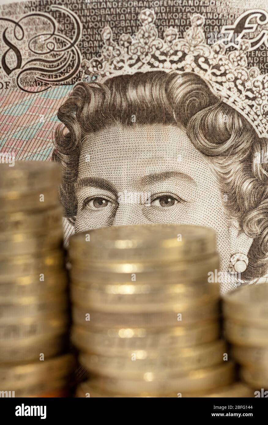 Illustrative image of a £50 note and stacks of pound coins Stock Photo ...