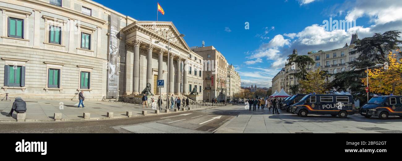 MADRID, SPAIN - DECEMBER 13, 2018: Congreso De Los Diputados in the Palace of the Parliament, or Plaza de las Cortes. Police cars parked in front of t Stock Photo