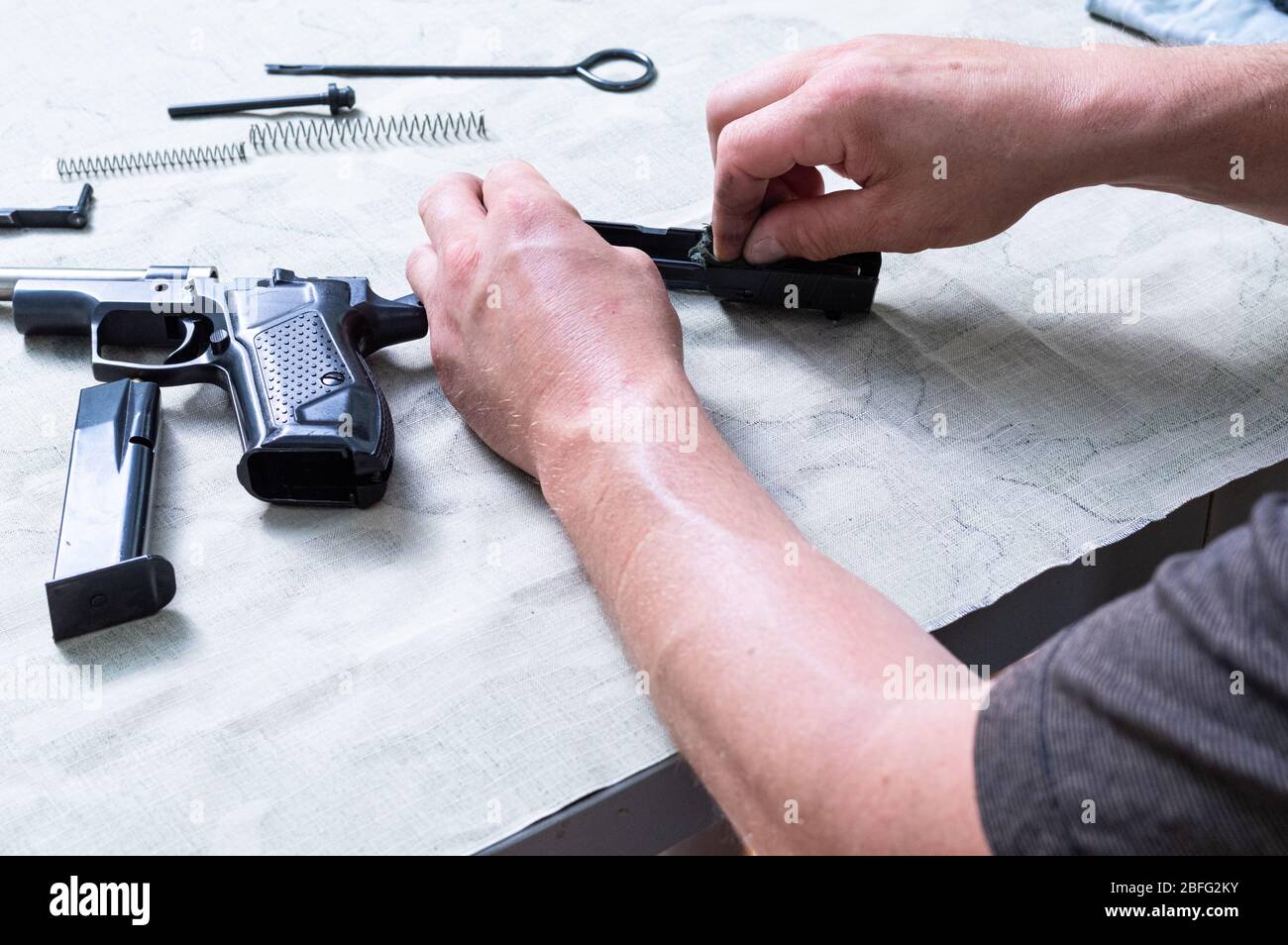 Assembly and disassembly of the gun. Details of the gun and hand Stock Photo Alamy