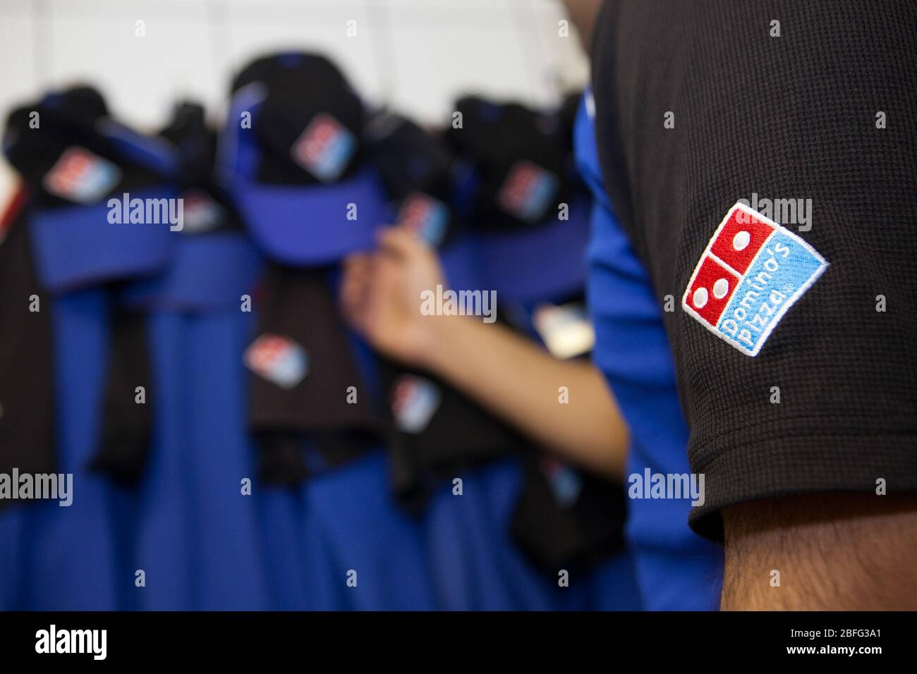 A Domino's Pizza employee gets ready for work Stock Photo Alamy