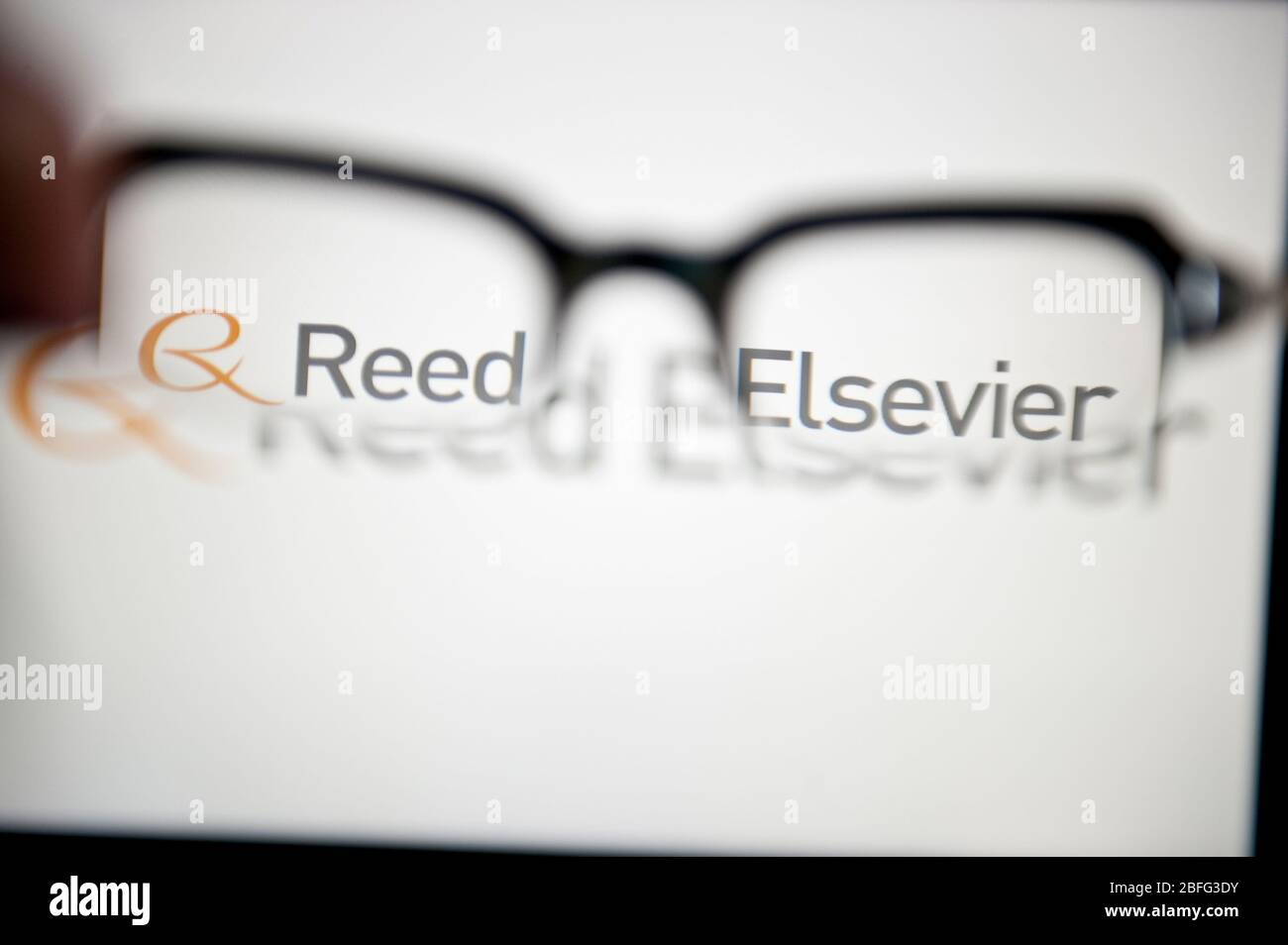 Reed Elsevier logo viewed through glasses Stock Photo - Alamy