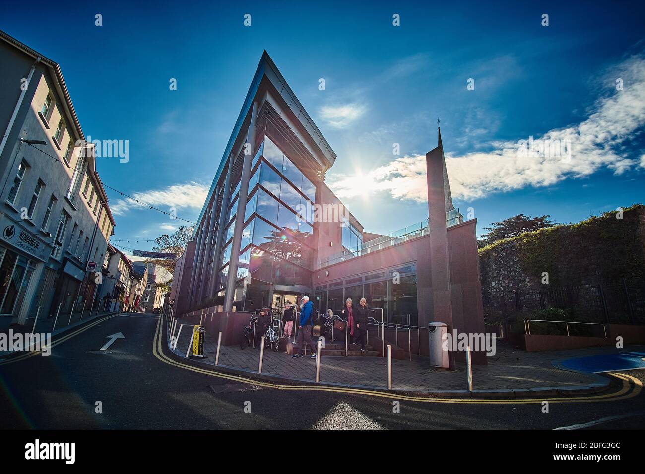 Dramatic backlit photograph of the Wexford Town Library in Wexford Ireland on a sunny day with blue shy with clouds Stock Photo