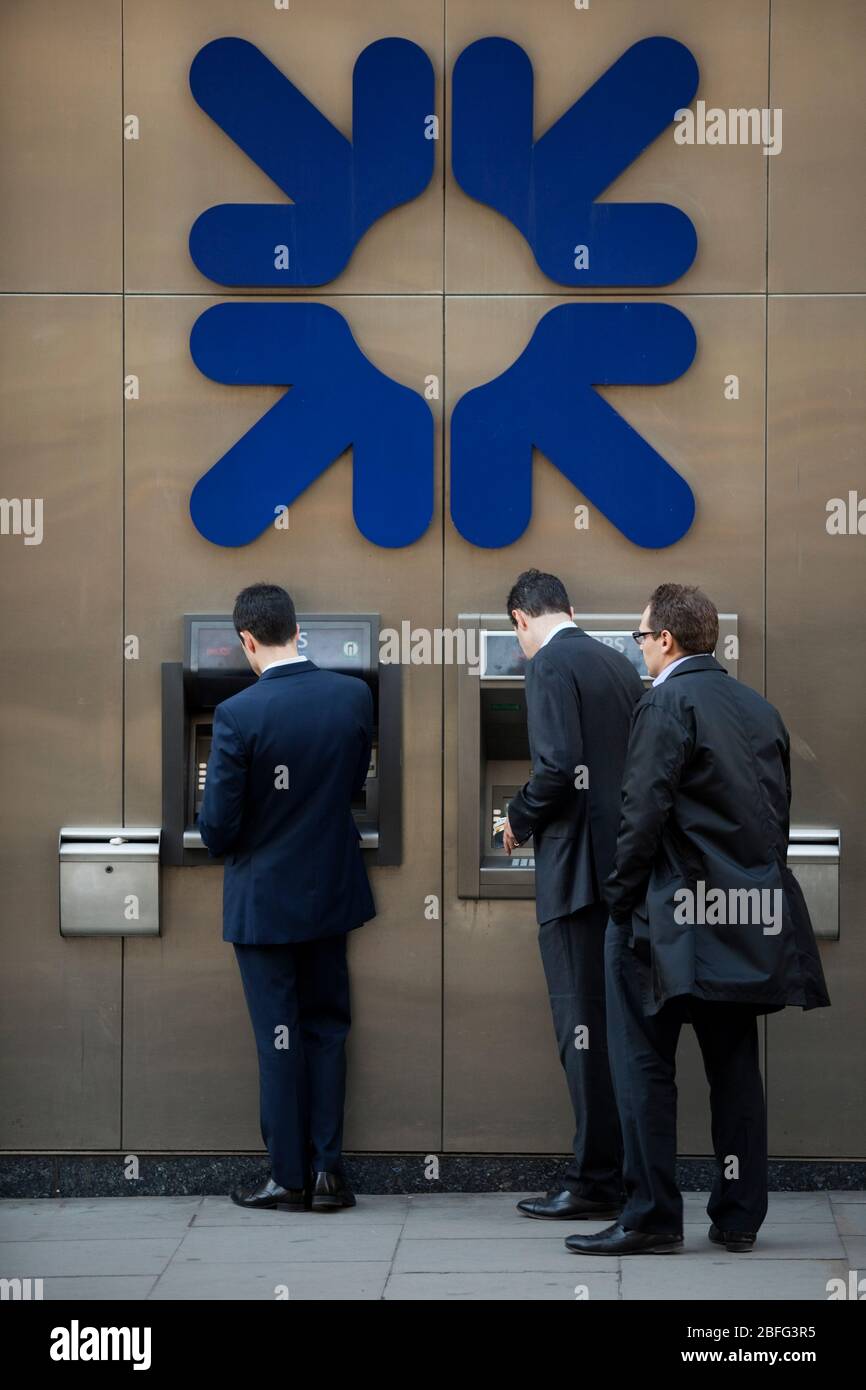 A group of men using RBS cash points Stock Photo Alamy