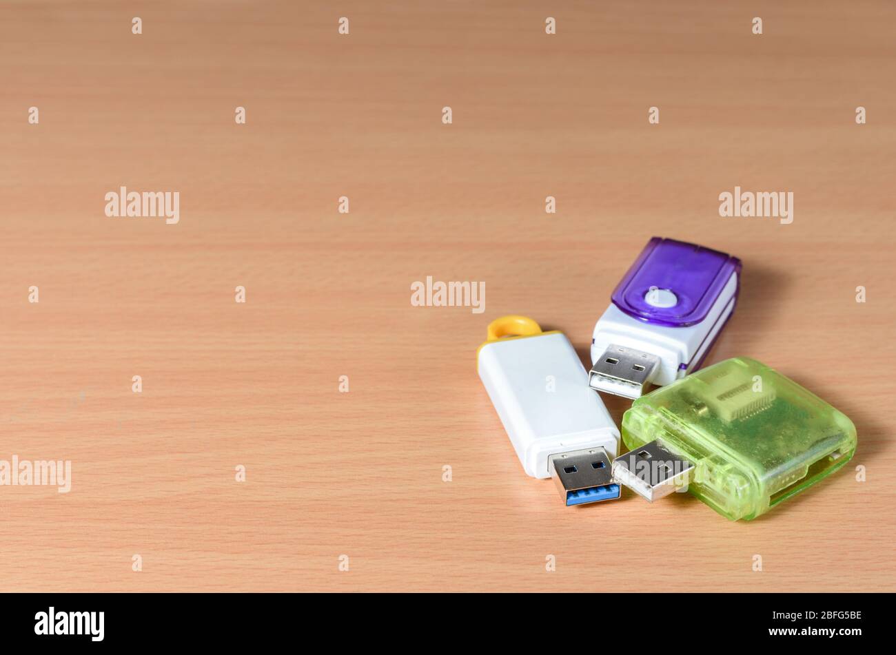Close-up of usb flash drive and sd card adapter on wooden background . Stock Photo