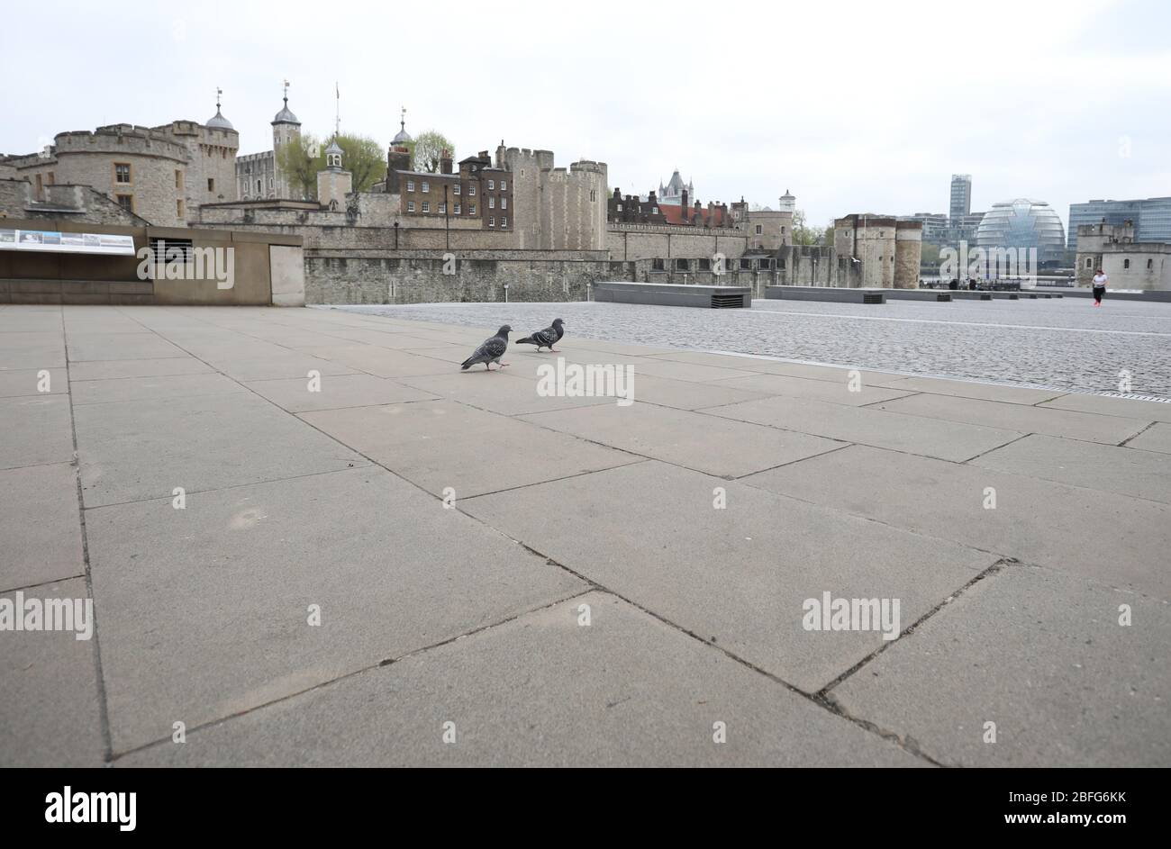 London, UK. 18th Apr, 2020. Day Twenty Six of Lockdown in London. Apart from a couple of pigeons and a handful of people, The Tower of London is deserted on a very quiet central London for a Saturday as the country is on lockdown due to the COVID-19 Coronavirus pandemic. People are not allowed to leave home except for minimal food shopping, medical treatment, exercise - once a day, and essential work. COVID-19 Coronavirus lockdown, London, UK, on April 18, 2020 Credit: Paul Marriott/Alamy Live News Stock Photo