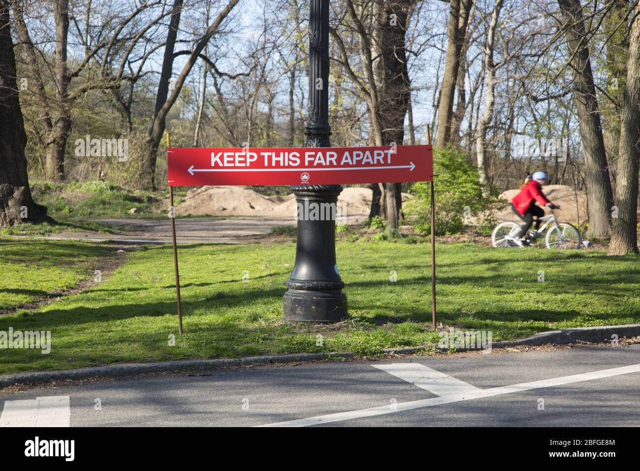 Sign at a Prospect Park entrance reminding people to practice social distancing of at least 6 feet while using the park during the Covid-19 pandemic.  Brooklyn, New York. Stock Photo
