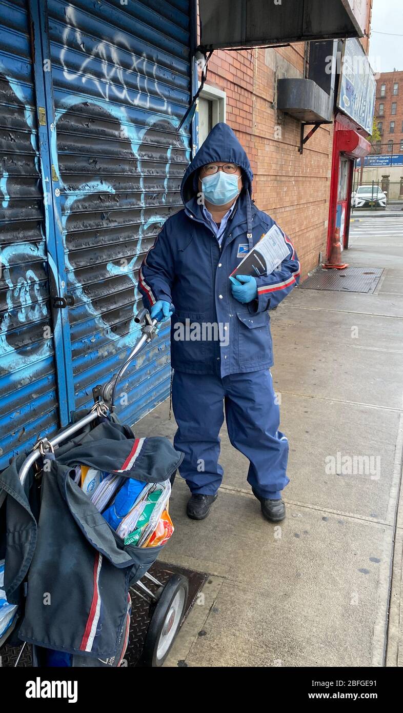 Portrait of a postal worker on the street in Brooklyn, NY, one of the essential workforce that keeps life functioning for the rest of us during the Coronavirus pandemic in the United States. Stock Photo