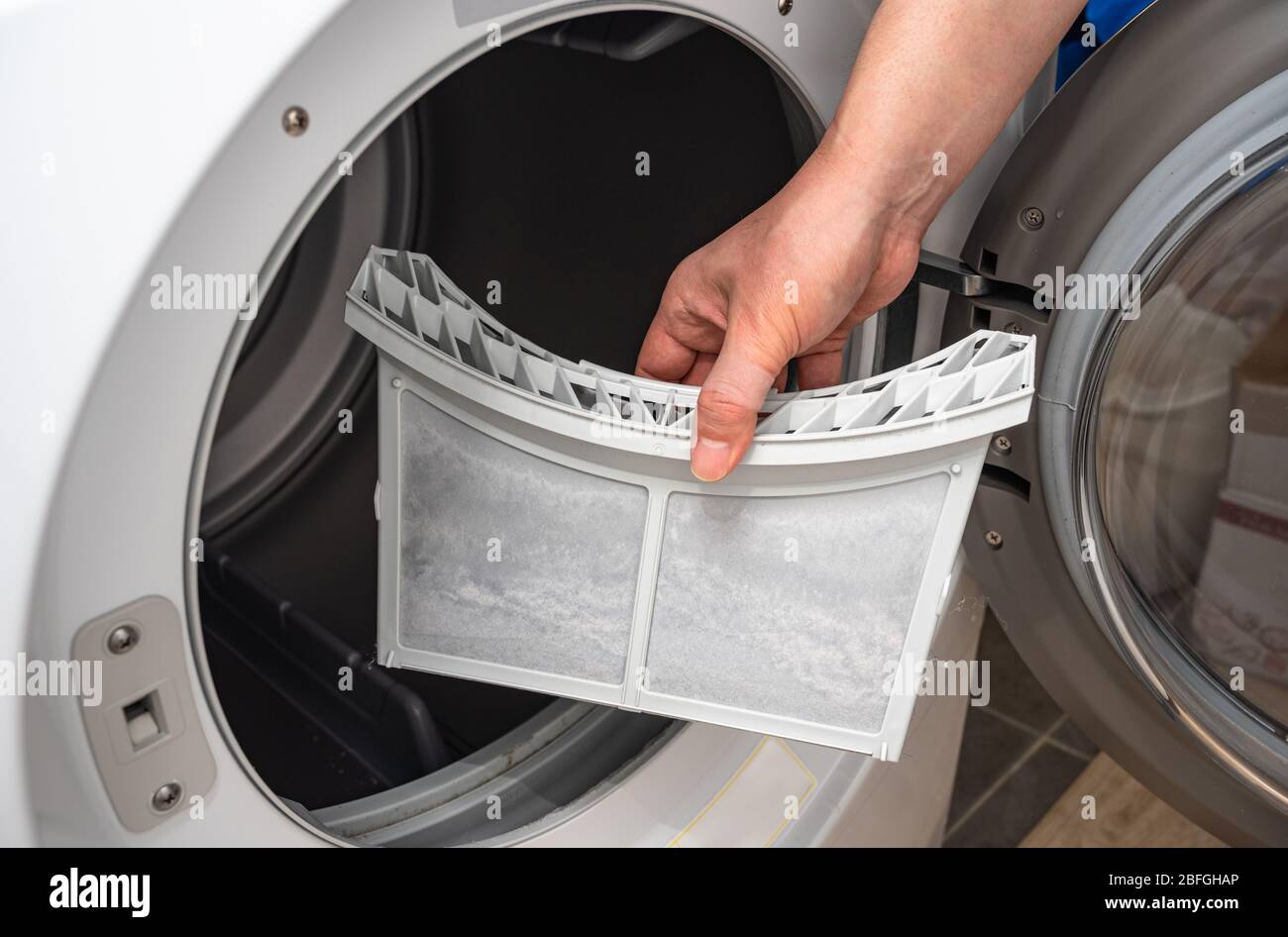 Dust and dirt trapped by the clothes dryer filter. Stock Photo