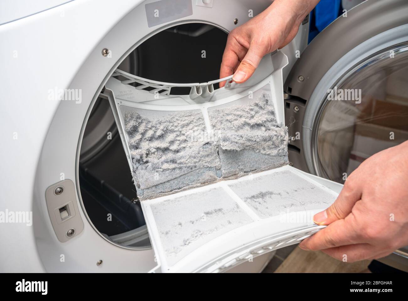 Dust and dirt trapped by the clothes dryer filter. Stock Photo