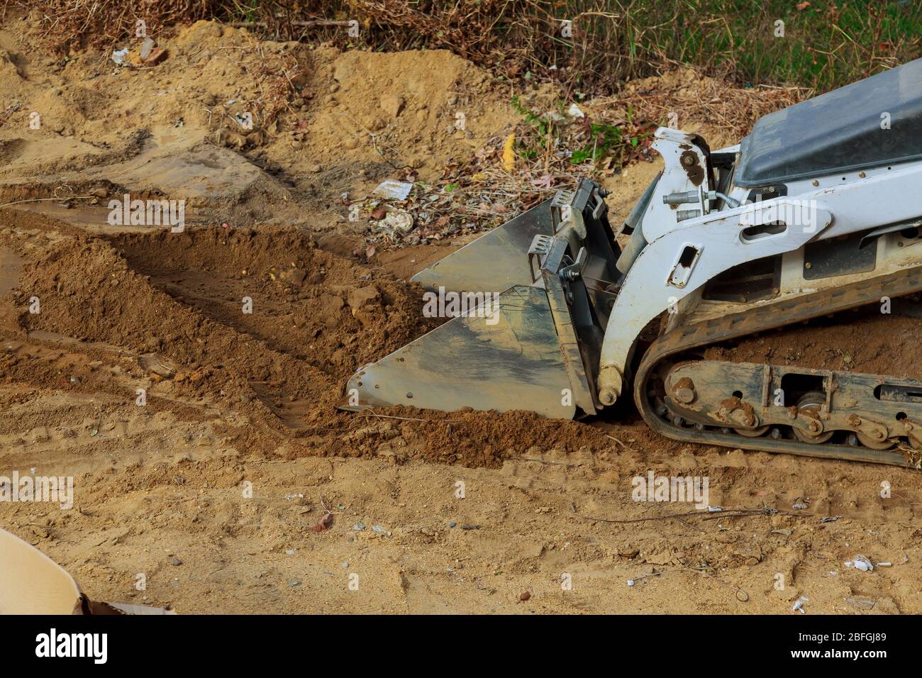 Bulldozer scoop working on the excavation works of moving earth Stock Photo