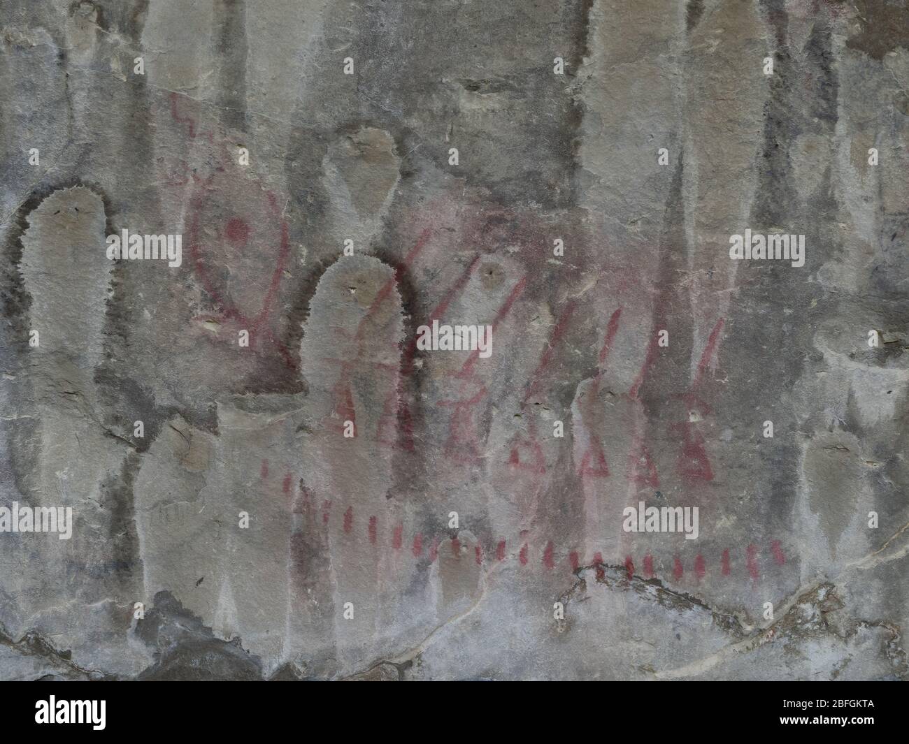 Close up of weapons and a tally of fallen enemies on a cave wall at Pictograph State Park in Billings, Montana Stock Photo