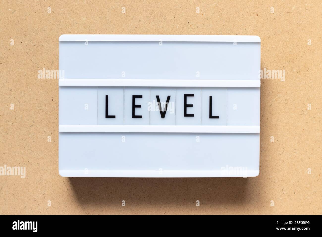 White lightbox with word level on wood background Stock Photo