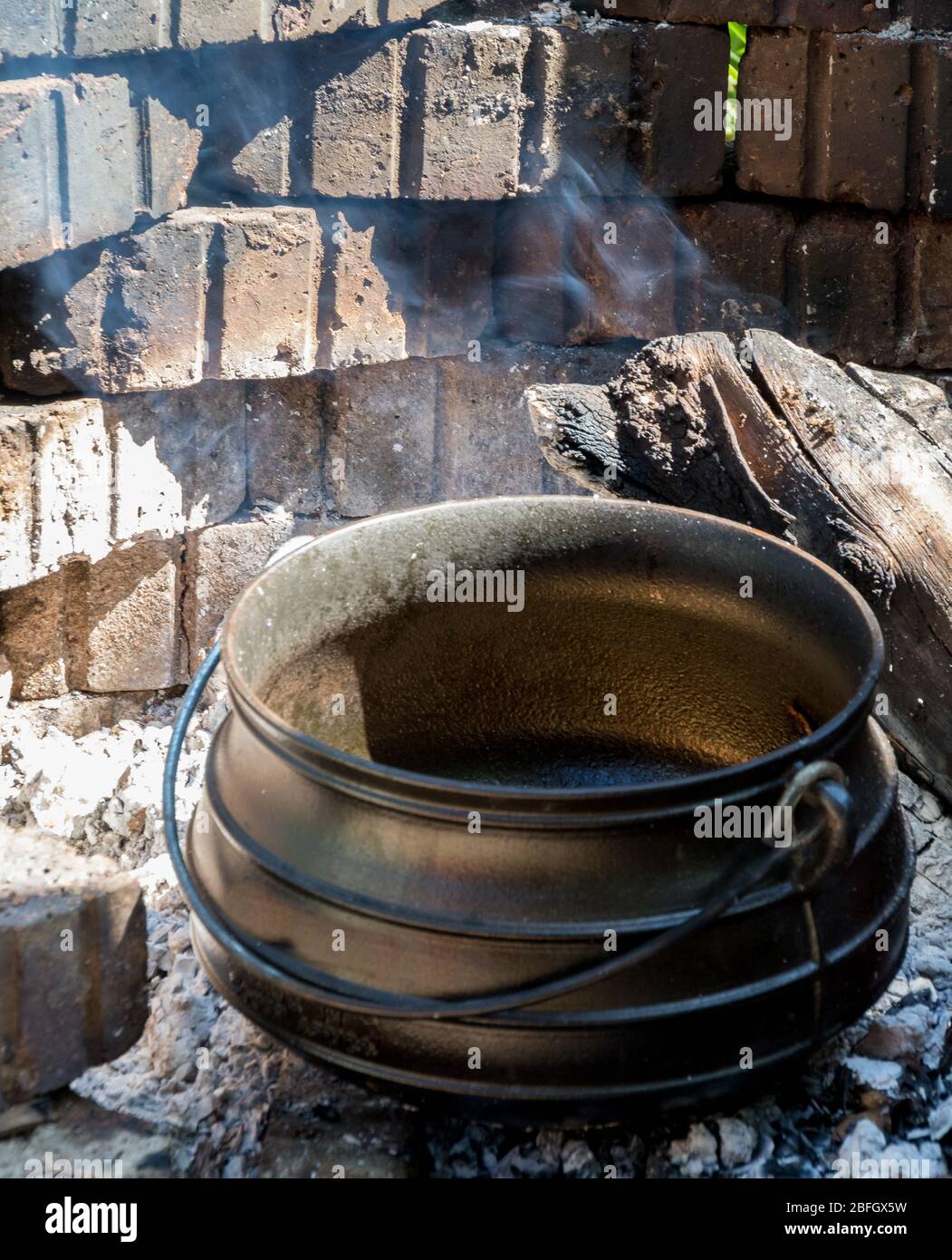 Food prepared outside on an open fire in a cast iron pot traditional