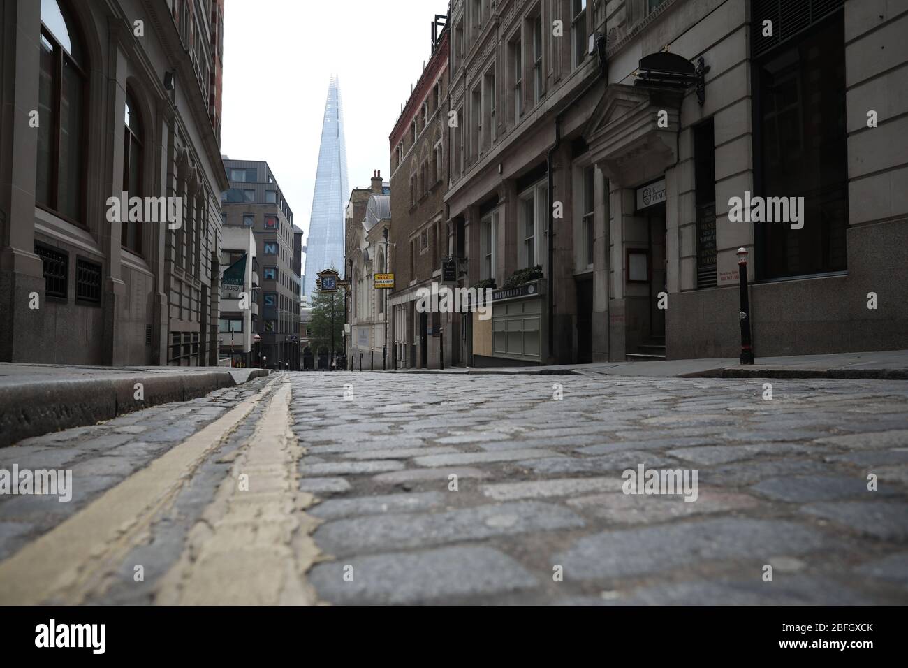London, UK. 18th Apr, 2020. Day Twenty Six of Lockdown in London. The Shard seen down a cobbled land, North of the river. A very quiet central London for a Saturday as the country is on lockdown due to the COVID-19 Coronavirus pandemic. People are not allowed to leave home except for minimal food shopping, medical treatment, exercise - once a day, and essential work. COVID-19 Coronavirus lockdown, London, UK, on April 18, 2020 Credit: Paul Marriott/Alamy Live News Stock Photo