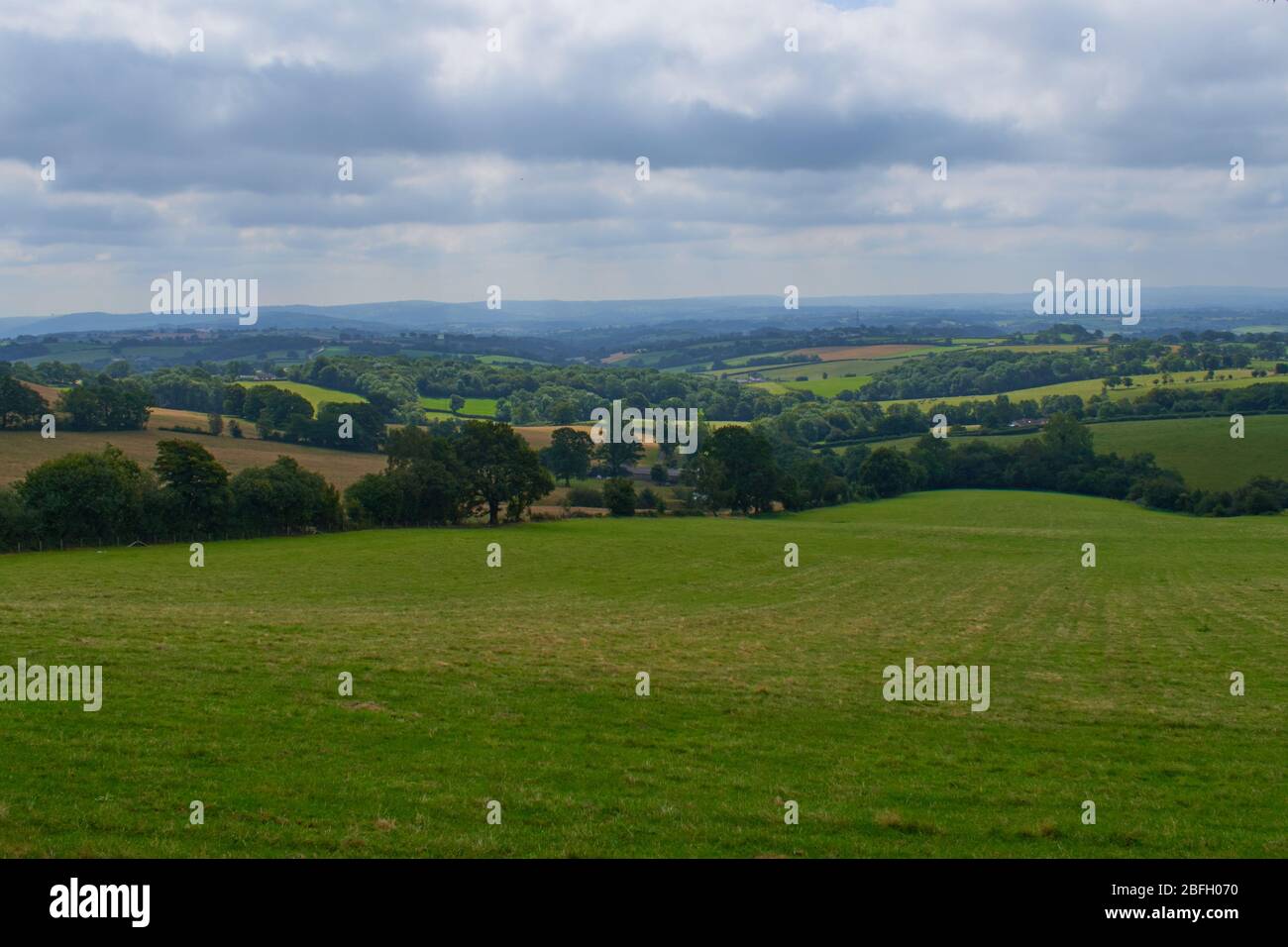 Rolling hills and over Herefordshire countryside under cloudy sky Stock Photo