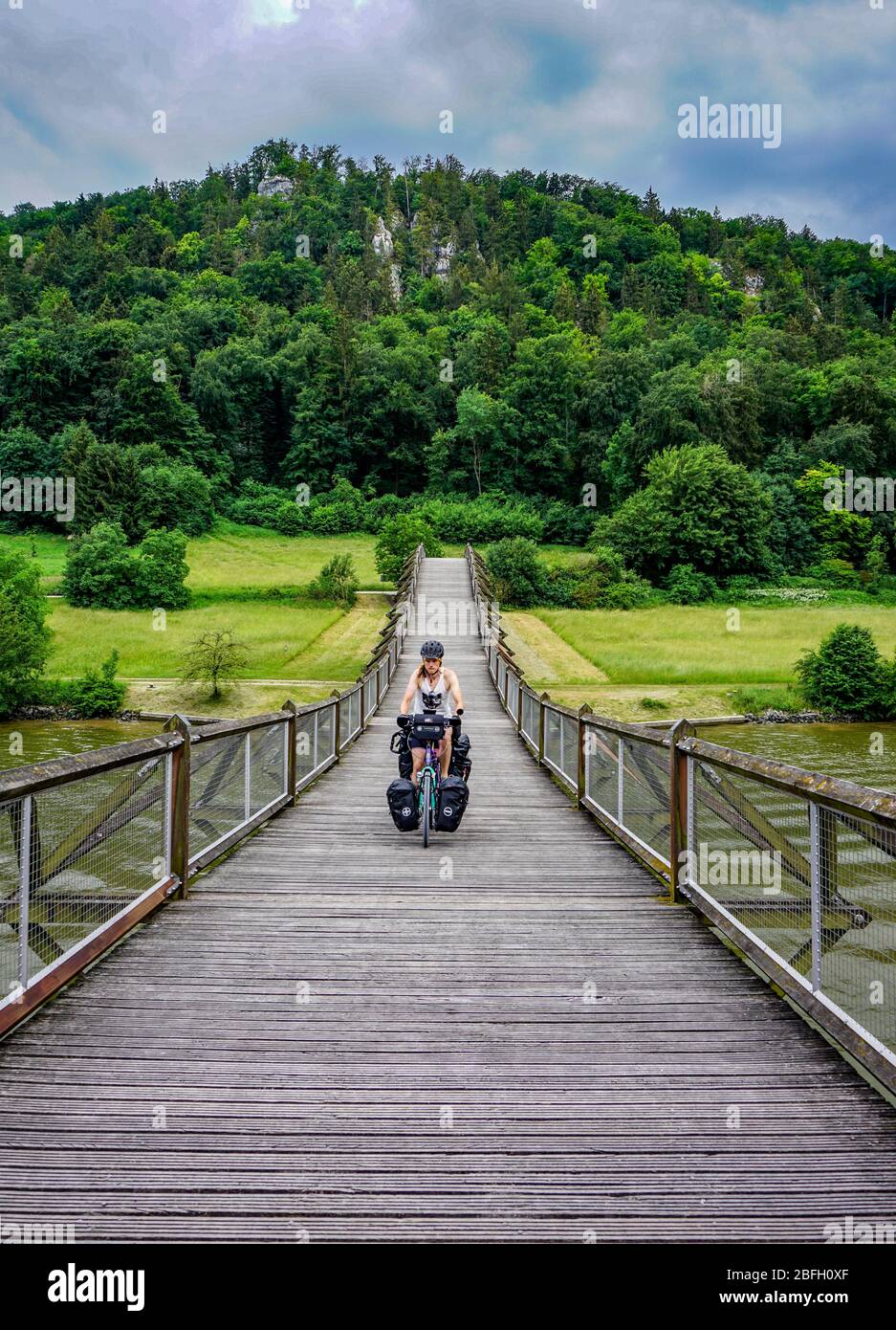 Bicycle world trip - passing a wooden bridge in the mountains. Stock Photo