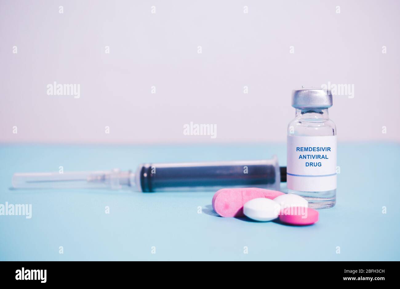 Remdesivir antiviral drug with pills and Syringe as background - concept of covd-19 or coronavirus new possible antiviral drug medication. Stock Photo