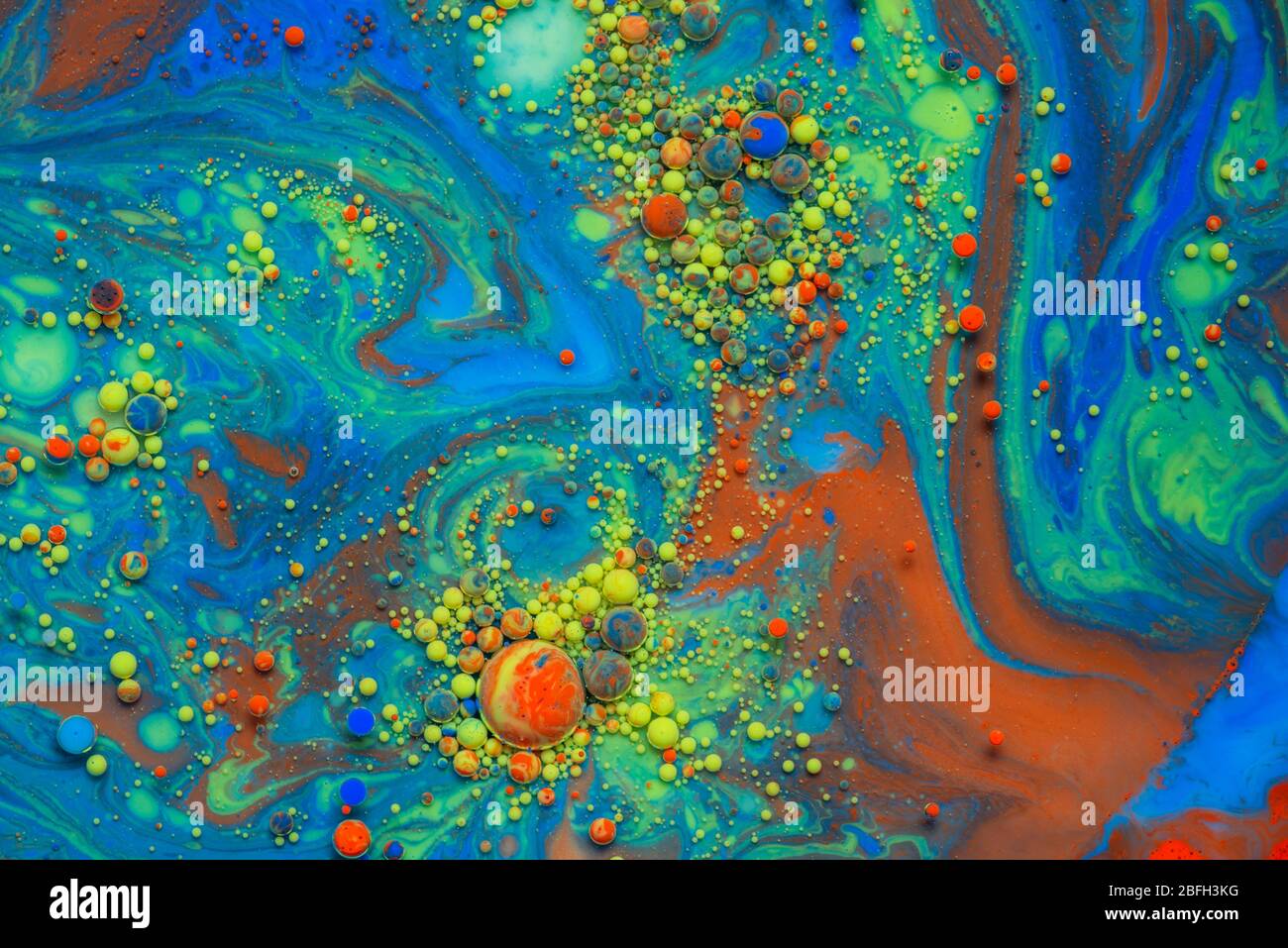 Colorful artistic background with various colors mixed with oil and milk Stock Photo