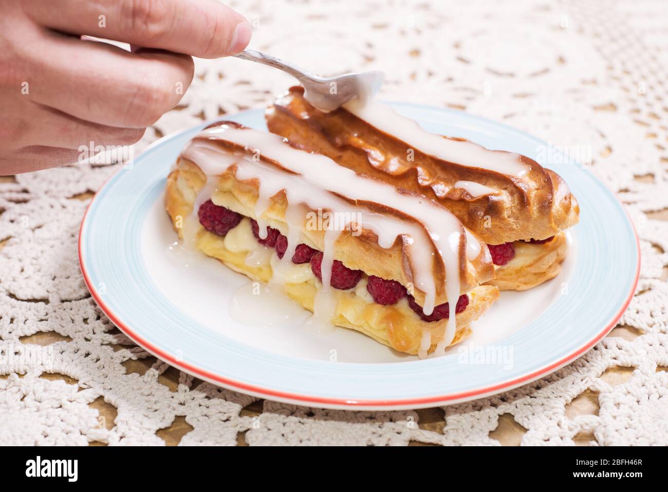 Eclairs with raspberries. delicious dessert Stock Photo
