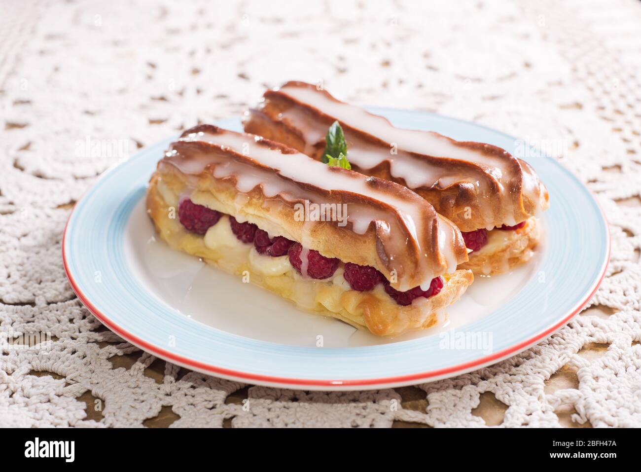 Eclairs with raspberries. delicious dessert Stock Photo