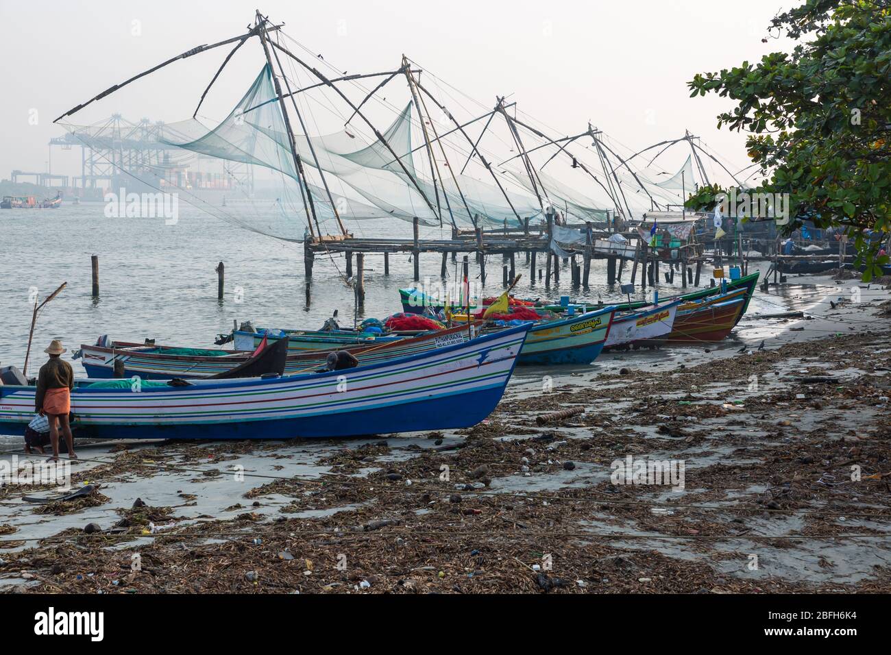 Kochi, Kerala - December 30, 2019: Fishing boats parked next to the chinese fishing nets in fort kochi, kerala india Stock Photo