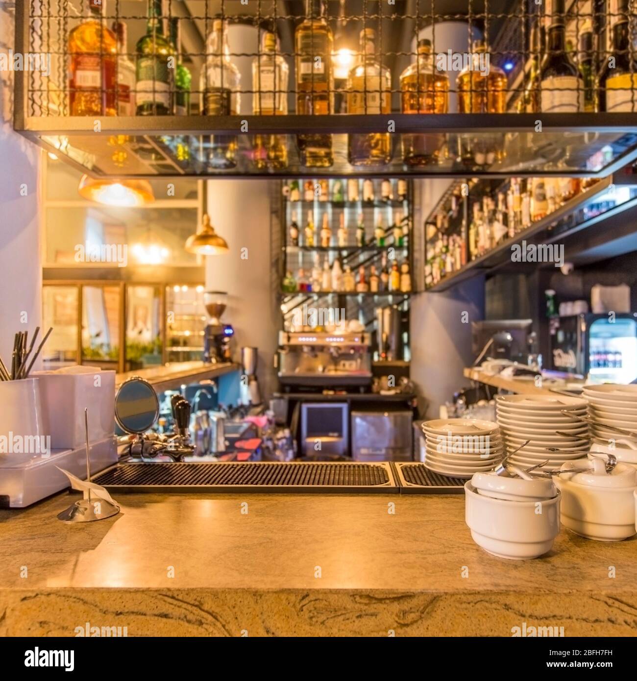 Clean dishes and view on bar counter in restaurant interior Stock Photo ...