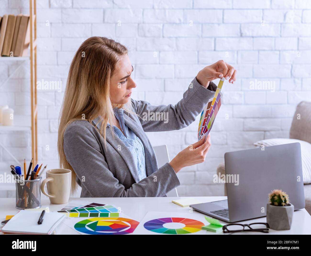 Remote work concept. Woman designer chooses color Stock Photo