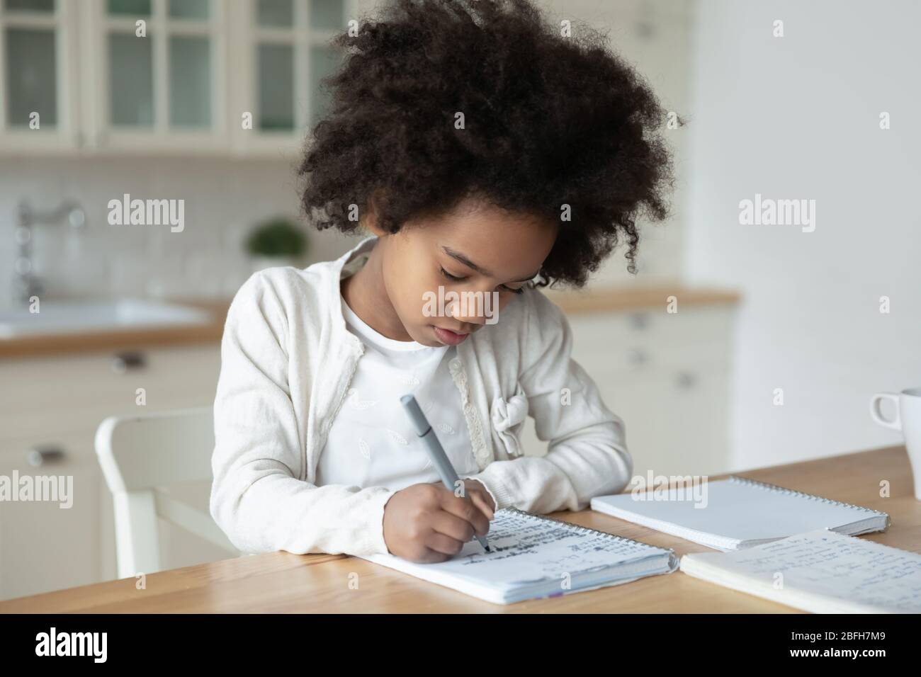 Small african American girl prepare homework at home Stock Photo