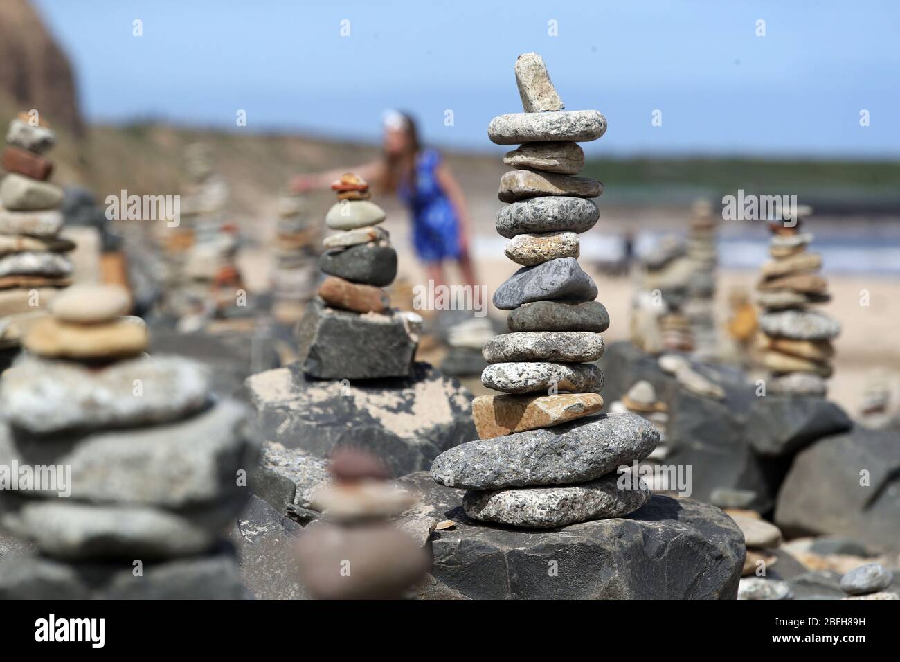Pebble sculptures in Whitley Bay beach on the North East coast, while people are taking their daily lockdown exercise they have kept adding pebble sculptures transforming the beach as the UK continues in lockdown to help curb the spread of the coronavirus. PA Photo Owen Humphreys . Stock Photo