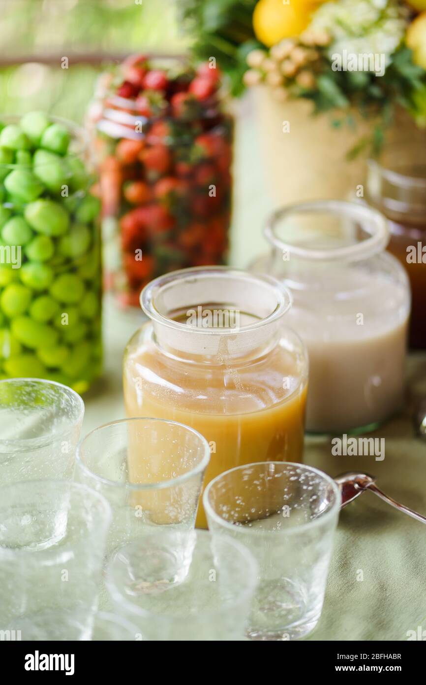 Traditional drinks from ginger and turmeric are served in large glass jars. Stock Photo