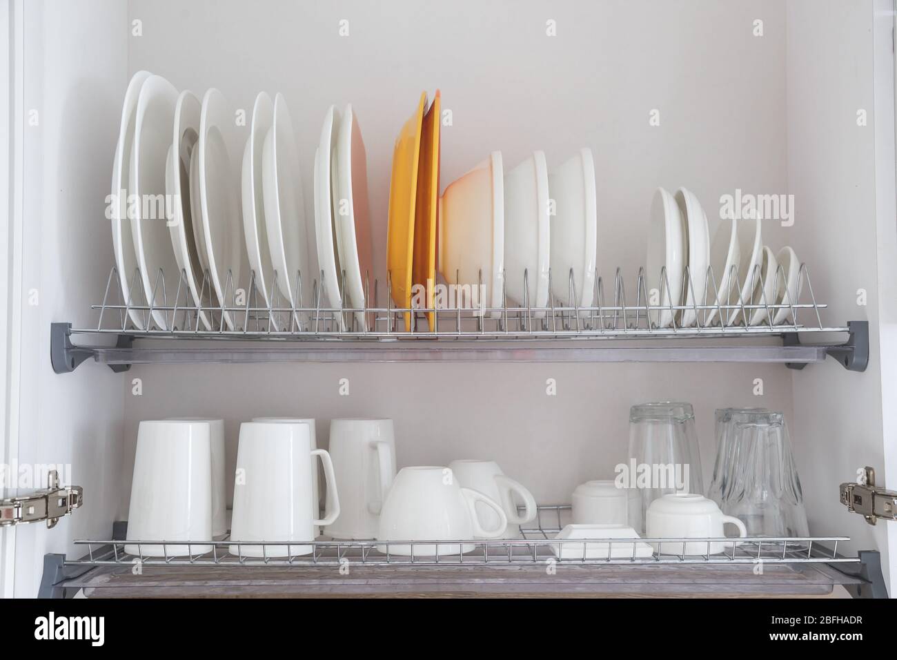 Utensils on metal rack in commercial kitchen Stock Photo - Alamy