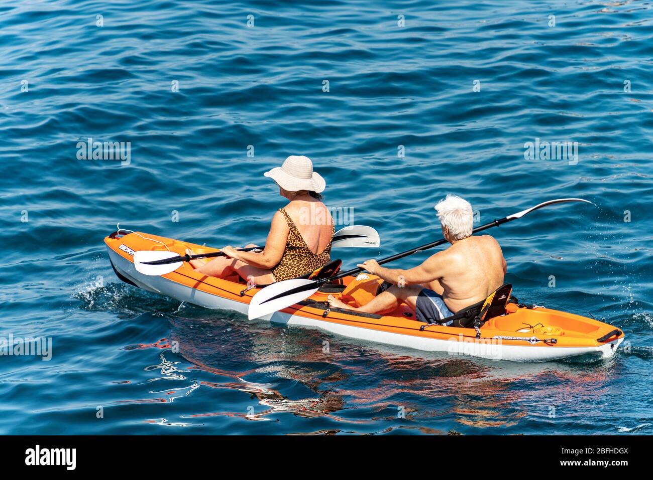 Woman paddling orange canoe hi-res stock photography and images - Alamy