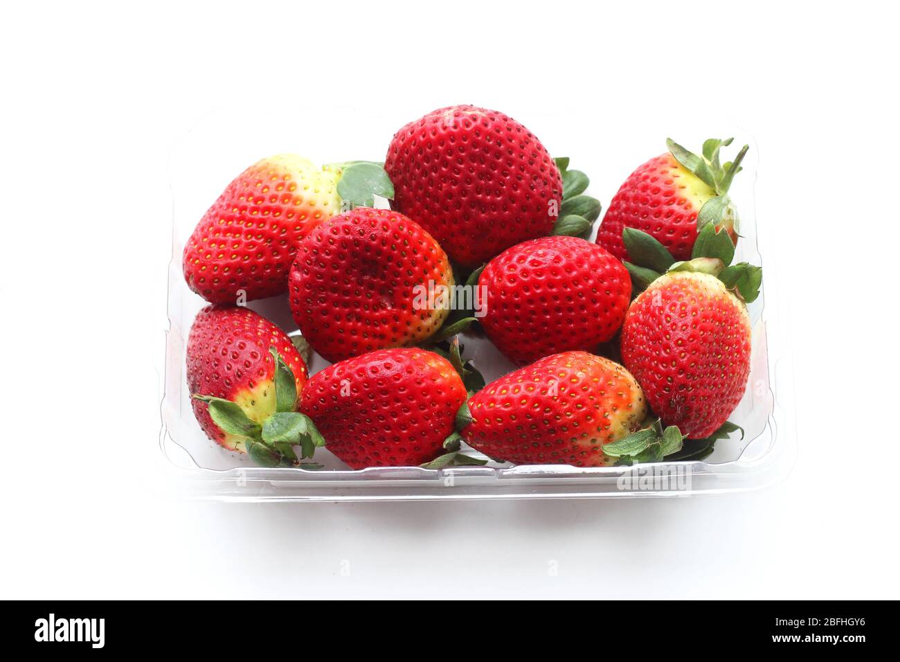 Close up of fresh strawberries isolated against white background Stock Photo