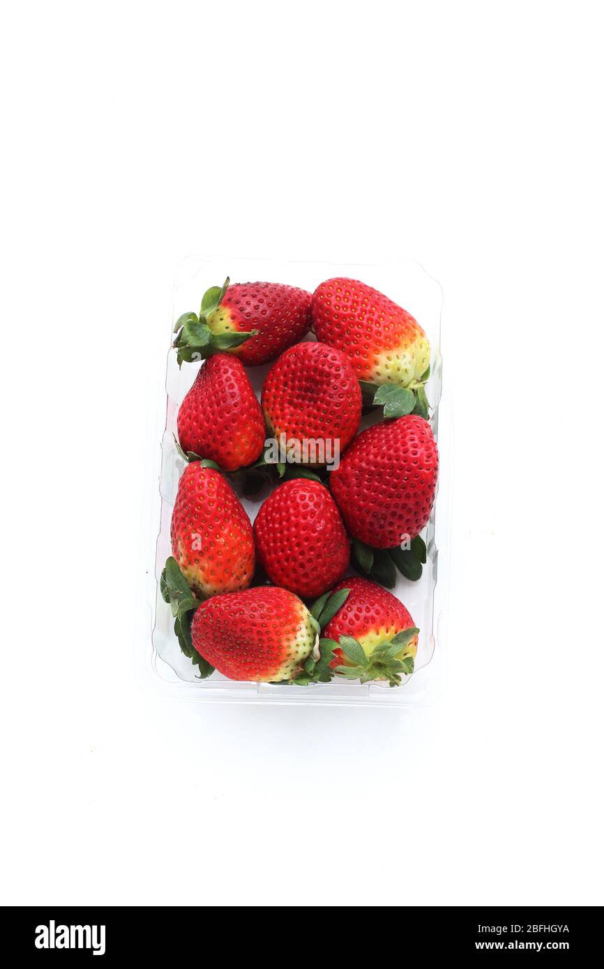 Close up of fresh strawberries isolated against white background Stock Photo