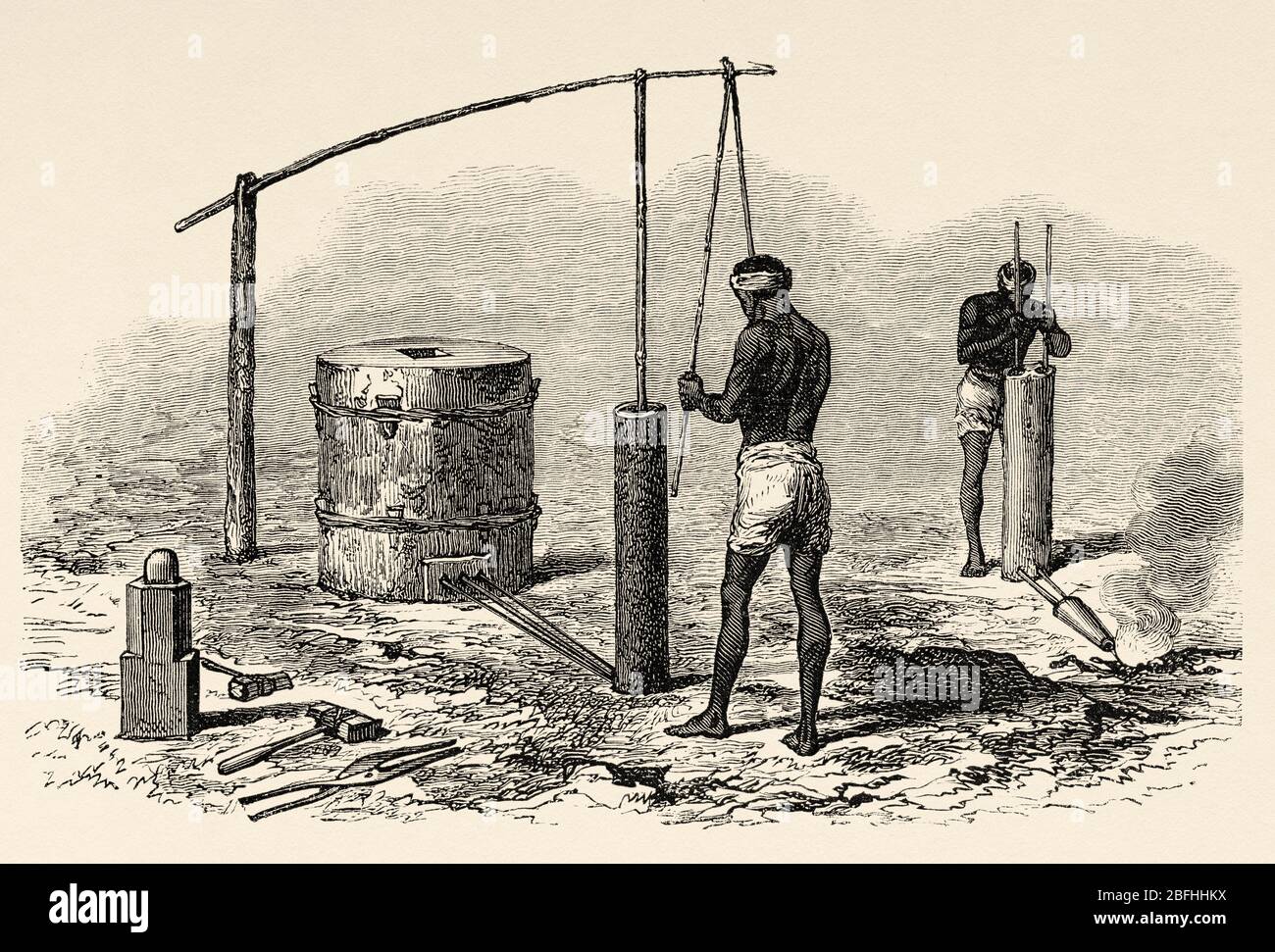 Traditional blacksmiths on Borneo island, Indonesia, Asia. Old engraving illustration, The Malay Archipelago by Alfred Russell Wallace Stock Photo
