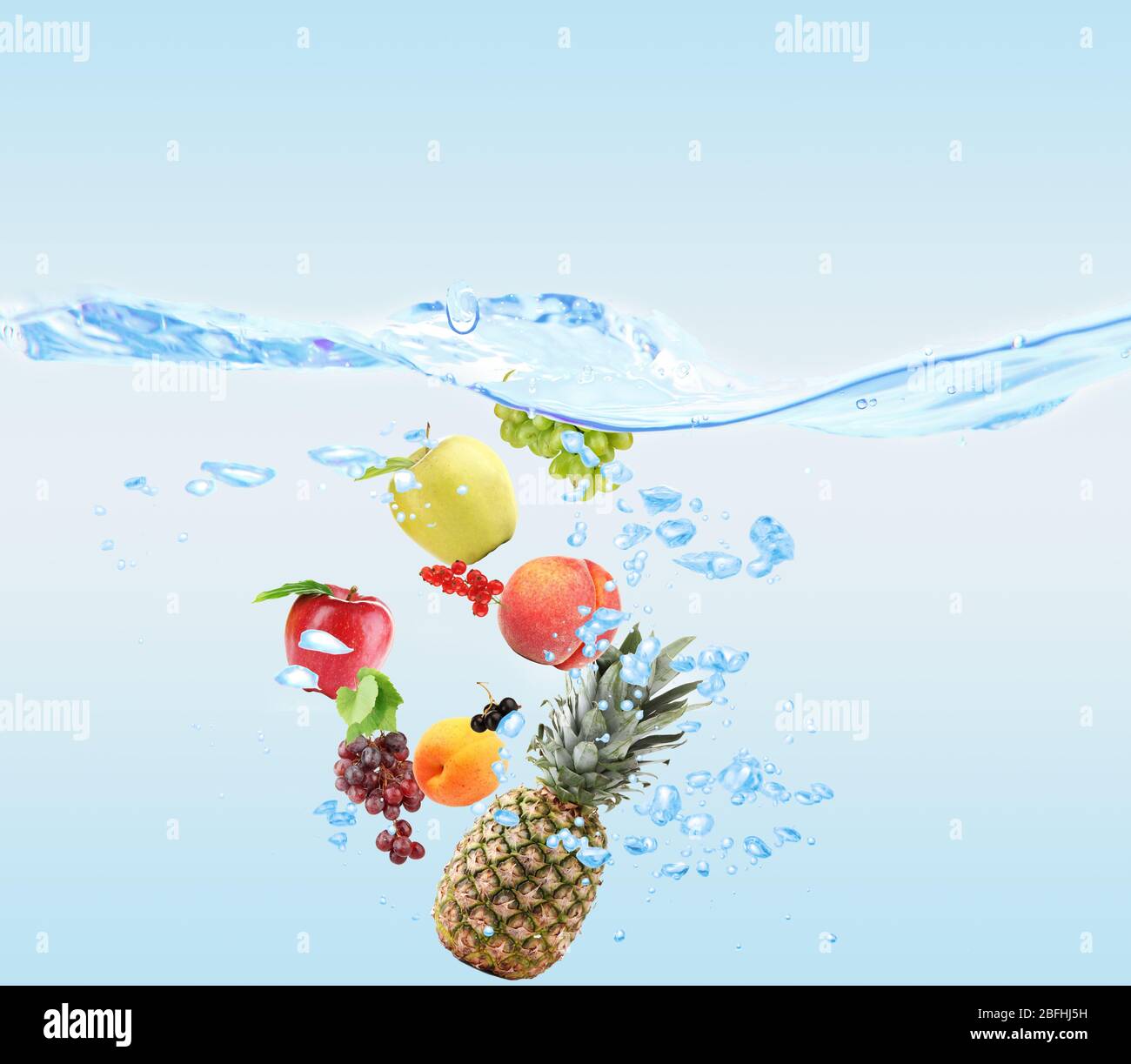Fresh fruits dropped into water Stock Photo