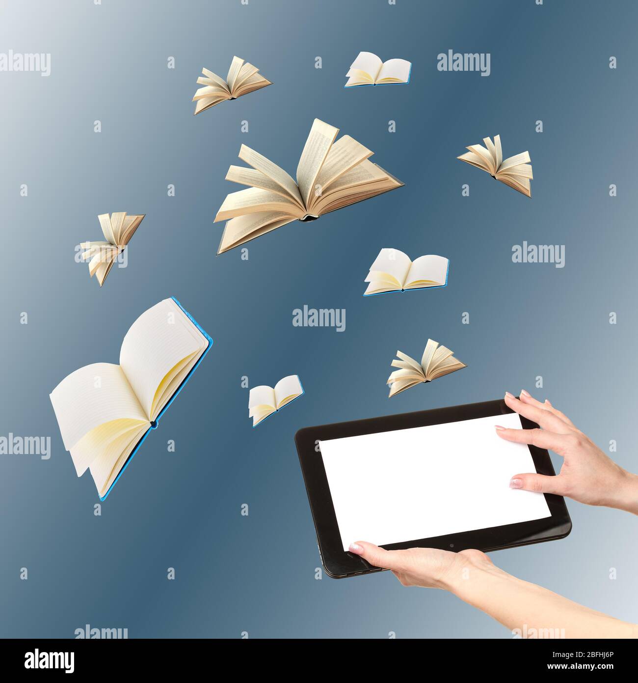 Tablet and opened books on blue background Stock Photo