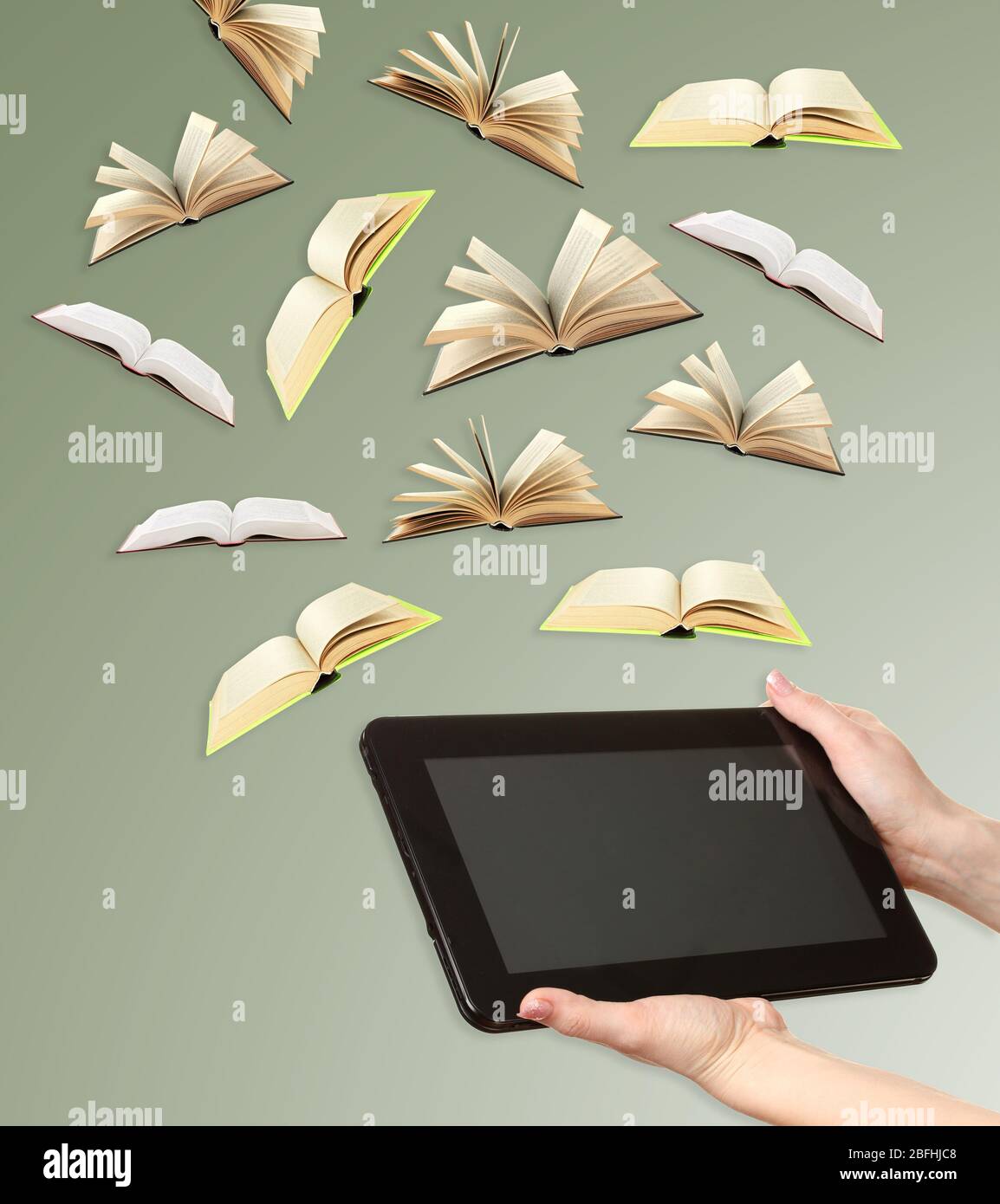 Tablet and opened books on grey background Stock Photo