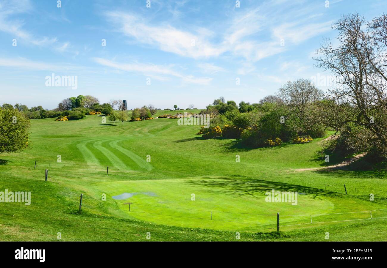 Golf course  in spring under blue, clouded sky now devoid of people due to Corona virus outbreak and following Government decree ordering shutdown. UK. Stock Photo