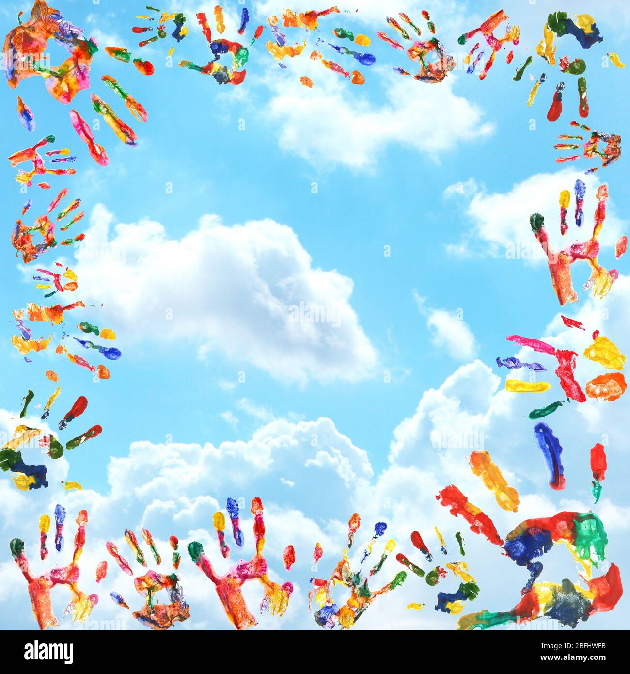 Frame of color hands print on sky background Stock Photo - Alamy